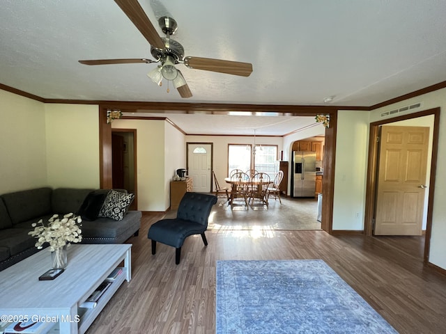 667-669 Ash Grove Rd, White Creek, NY 12816 - living room featuring wood finished floors, ornamental molding, ceiling fan, a chandelier, and baseboards