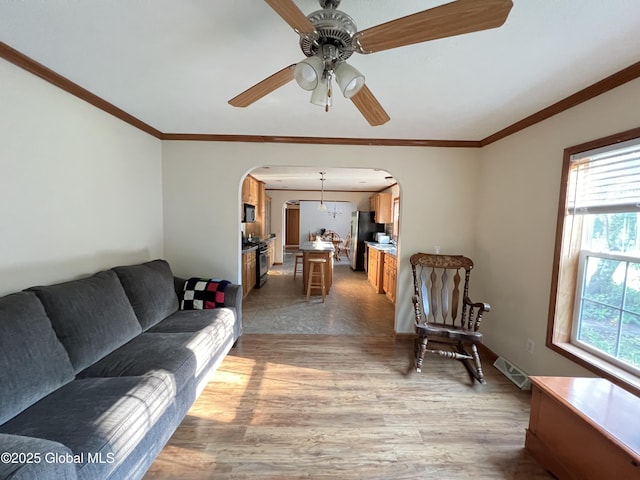 667-669 Ash Grove Rd, White Creek, NY 12816 - living area featuring arched walkways, a ceiling fan, wood finished floors, and crown molding