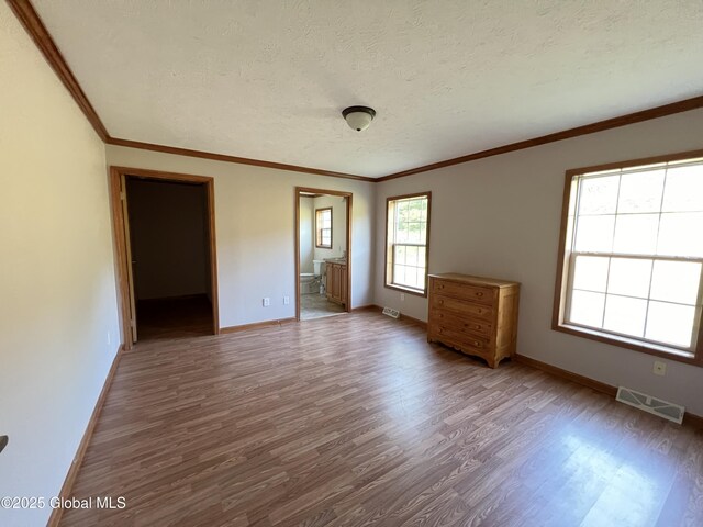 667-669 Ash Grove Rd, White Creek, NY 12816 - spare room with wood finished floors, baseboards, a textured ceiling, and crown molding