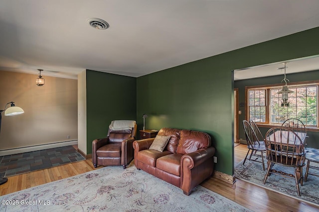 7 Western Ave, Charlton, NY 12019 - living area with a baseboard radiator, wood finished floors, and baseboards