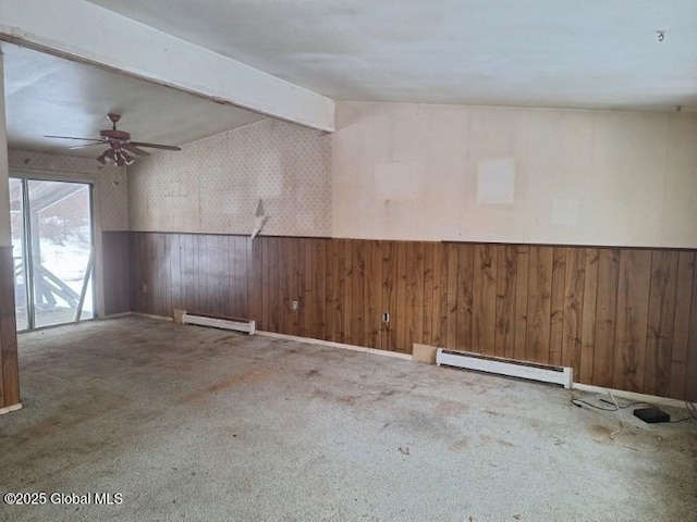 2459 Delaware Tpke, New Scotland, NY 12186 - carpeted empty room with a baseboard heating unit, wood walls, a wainscoted wall, and ceiling fan