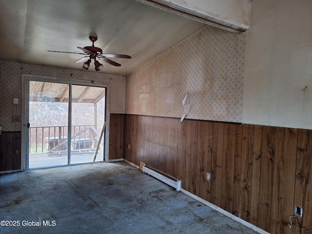 2459 Delaware Tpke, New Scotland, NY 12186 - spare room with baseboard heating, a wainscoted wall, wallpapered walls, ceiling fan, and wooden walls