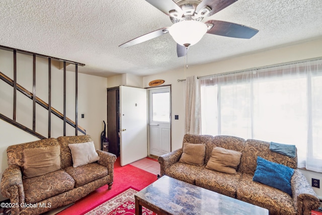 27 Columbia St, Hudson, NY 12534 - living room with a textured ceiling, a ceiling fan, wood finished floors, and stairway
