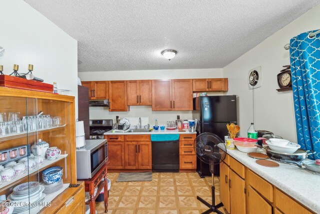 27 Columbia St, Hudson, NY 12534 - kitchen featuring dishwasher, range hood, freestanding refrigerator, light countertops, and a textured ceiling