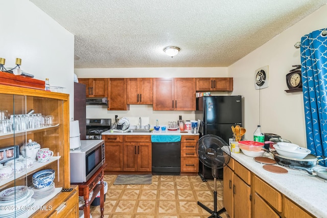 27 Columbia St, Hudson, NY 12534 - kitchen featuring black appliances, exhaust hood, light countertops, a sink, and a textured ceiling