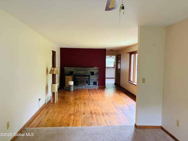 8 Lee Ave, Rexford, NY 12148 - unfurnished living room with a fireplace, baseboards, and wood finished floors