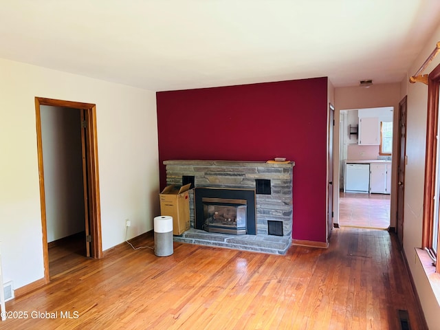 8 Lee Ave, Rexford, NY 12148 - unfurnished living room featuring wood-type flooring and a stone fireplace