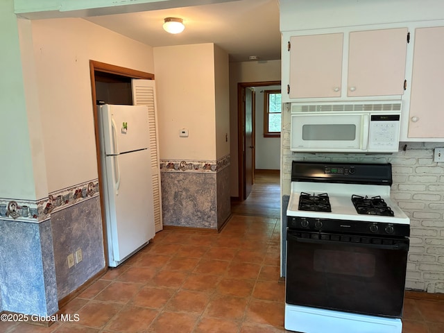 8 Lee Ave, Rexford, NY 12148 - kitchen with white appliances, wainscoting, white cabinetry, and tile patterned flooring