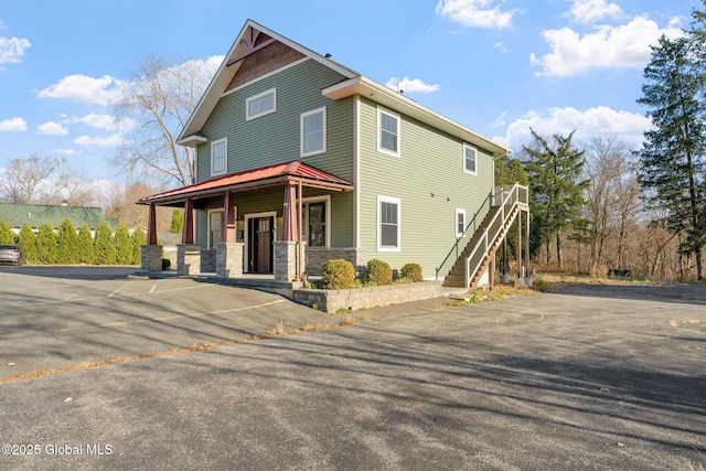 658 Saratoga Rd, Glenville, NY 12302 - view of front of house featuring covered porch, stairway, and stone siding