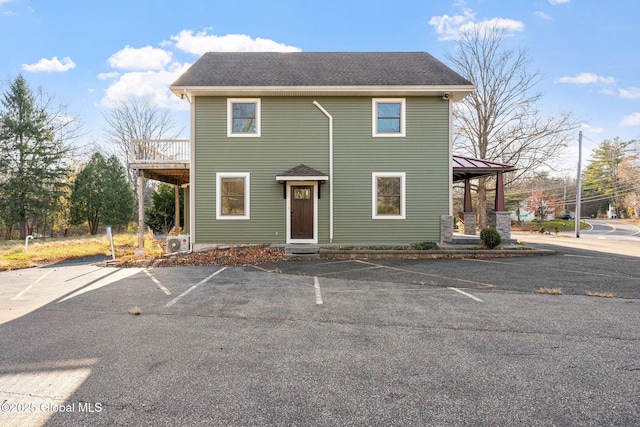 658 Saratoga Rd, Glenville, NY 12302 - view of front of house with uncovered parking, a cooling unit, and roof with shingles