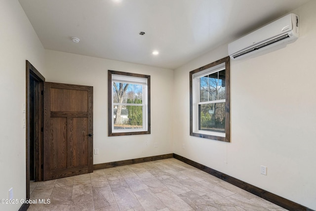 658 Saratoga Rd, Glenville, NY 12302 - unfurnished bedroom featuring an AC wall unit, multiple windows, baseboards, and recessed lighting