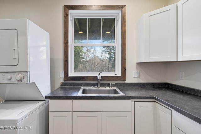 658 Saratoga Rd, Glenville, NY 12302 - laundry area featuring stacked washing machine and dryer and cabinet space
