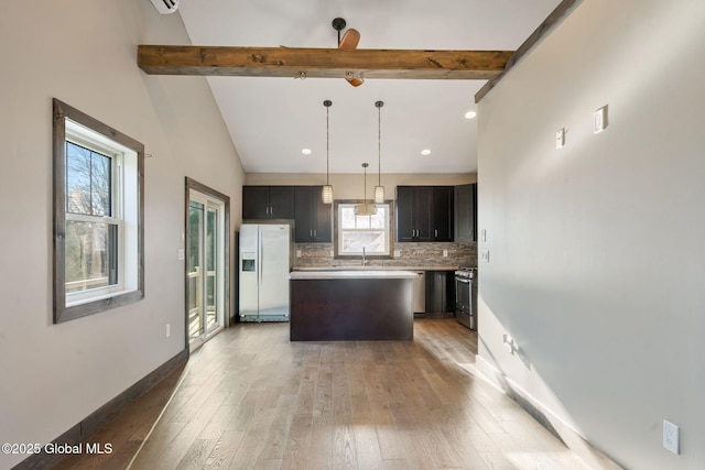 658 Saratoga Rd, Glenville, NY 12302 - kitchen featuring appliances with stainless steel finishes, a kitchen island, plenty of natural light, and decorative backsplash
