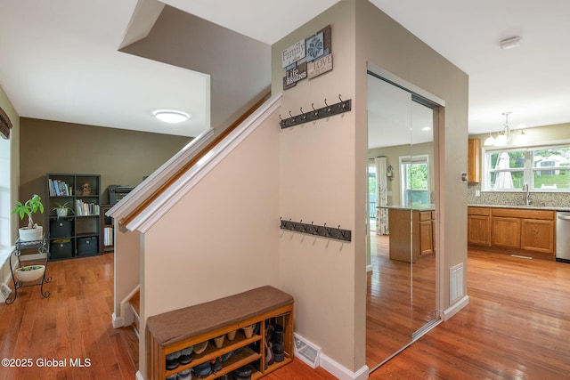 51 Wynantskill Way, Troy, NY 12180 - stairs with wood finished floors and a chandelier