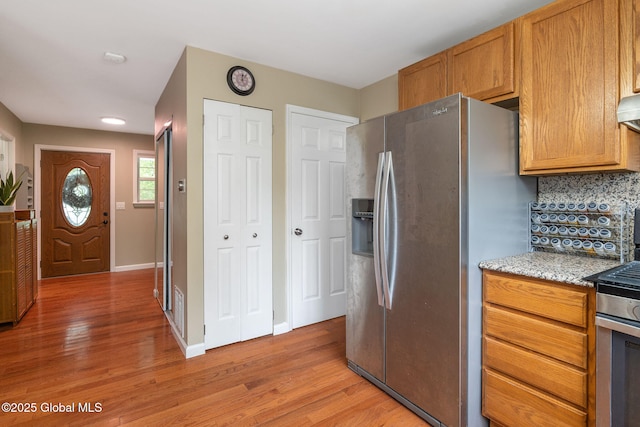 51 Wynantskill Way, Troy, NY 12180 - kitchen featuring stainless steel appliances, light wood finished floors, backsplash, and light stone counters