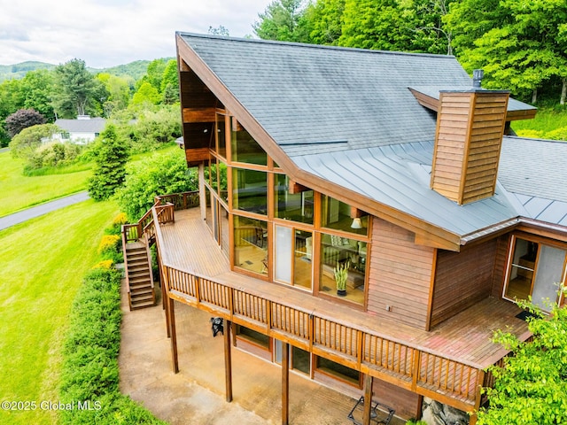 47 County Route 28, Hebron, NY 12832 - rear view of house with a deck with mountain view, a standing seam roof, stairs, a chimney, and metal roof