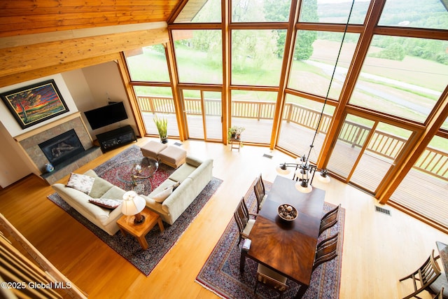 47 County Route 28, Hebron, NY 12832 - living room featuring a fireplace, wood finished floors, and lofted ceiling