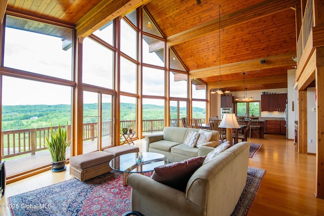 47 County Route 28, Hebron, NY 12832 - living room featuring high vaulted ceiling, wooden ceiling with exposed beams, expansive windows, and light wood-style flooring