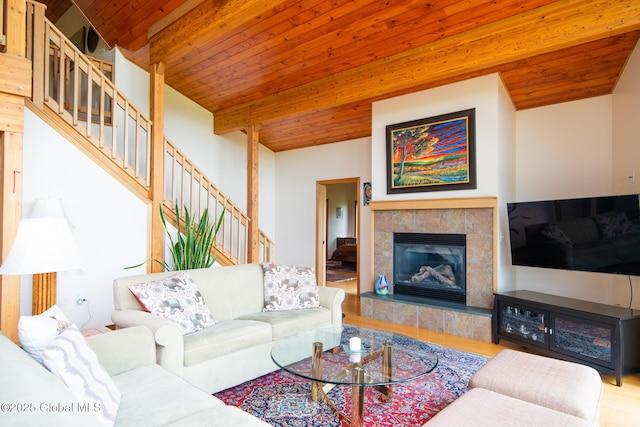 47 County Route 28, Hebron, NY 12832 - living room with stairs, wood ceiling with exposed beams, wood finished floors, and a tiled fireplace