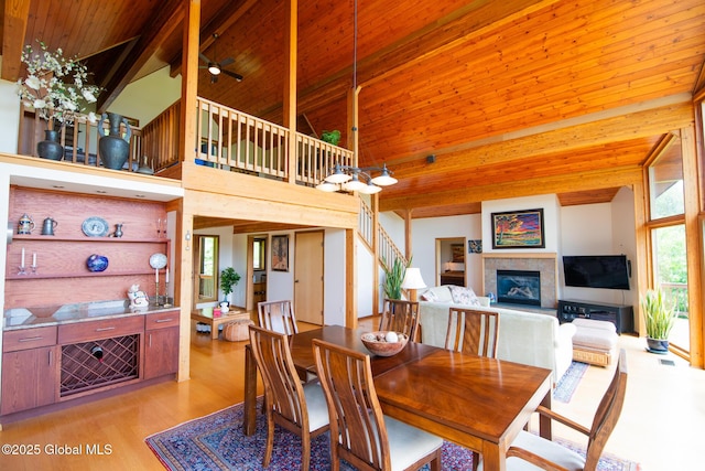47 County Route 28, Hebron, NY 12832 - dining area featuring wood ceiling, light wood finished floors, high vaulted ceiling, a tile fireplace, and ceiling fan