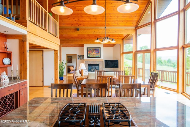 47 County Route 28, Hebron, NY 12832 - dining room featuring a high ceiling, a glass covered fireplace, and wooden ceiling