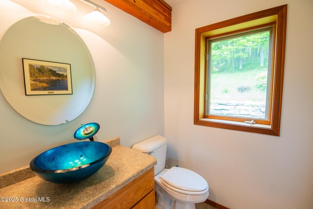 47 County Route 28, Hebron, NY 12832 - bathroom featuring vanity, toilet, and baseboards