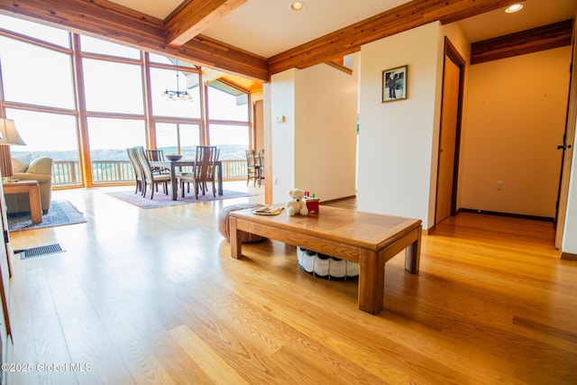 47 County Route 28, Hebron, NY 12832 - living room with a chandelier, beamed ceiling, light wood-style floors, expansive windows, and recessed lighting