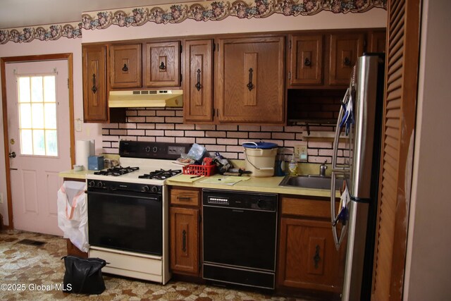 58 Fisler Ave, Colonie, NY 12304 - kitchen featuring black dishwasher, range with gas stovetop, under cabinet range hood, light countertops, and backsplash