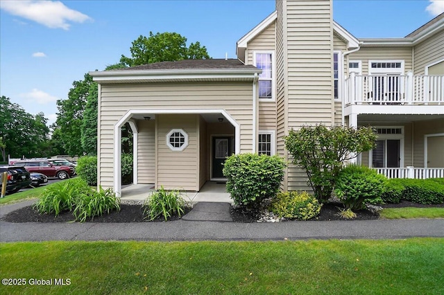 713 Hampton Place Blvd, North Greenbush, NY 12180 - view of property featuring a chimney and a balcony
