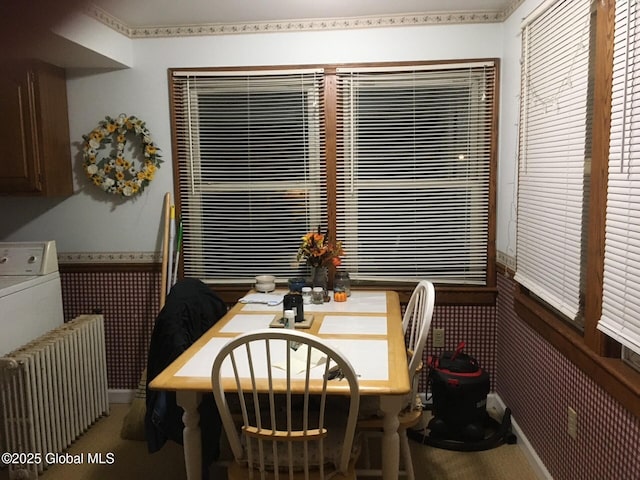 3810 Main St, Warrensburg, NY 12885 - carpeted dining space featuring wainscoting, radiator heating unit, and washer / dryer