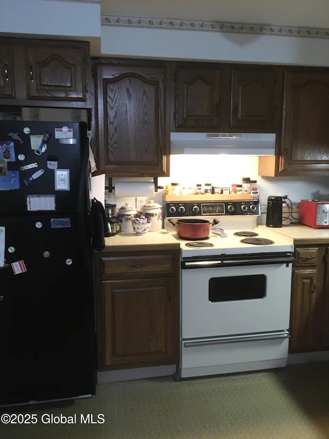 3810 Main St, Warrensburg, NY 12885 - kitchen featuring white range with electric cooktop, freestanding refrigerator, under cabinet range hood, light countertops, and dark brown cabinets