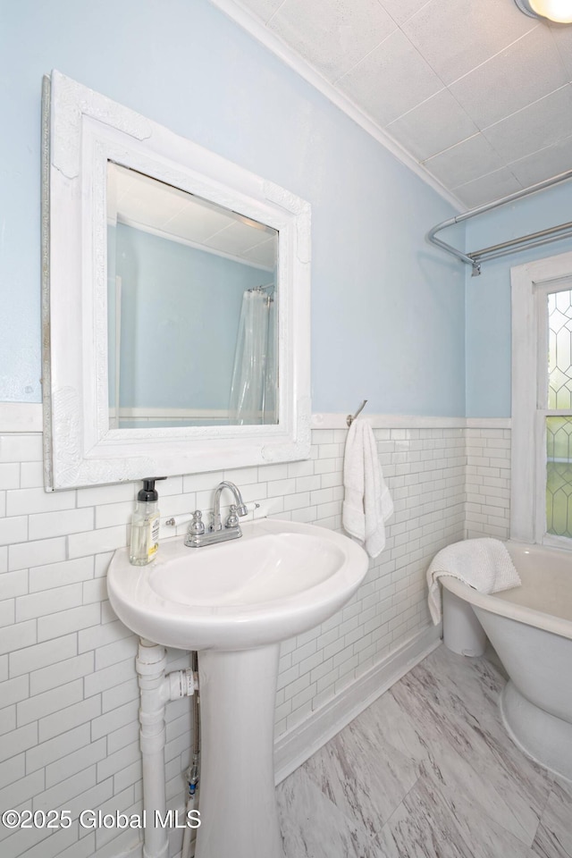 970 Main St, Clifton Park, NY 12065 - bathroom with tile walls, a wainscoted wall, a sink, and ornamental molding