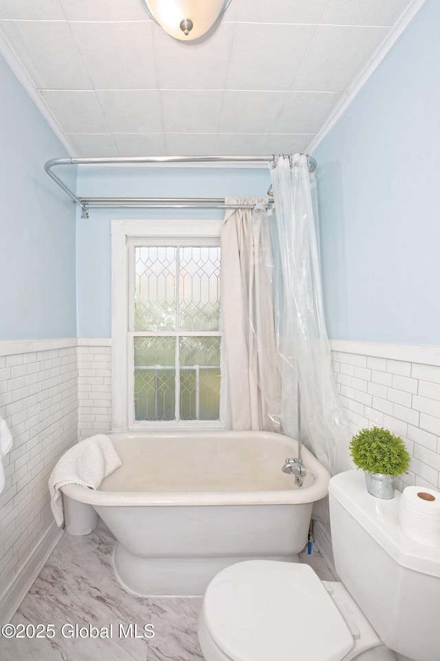 970 Main St, Clifton Park, NY 12065 - full bathroom featuring tile walls, toilet, and wainscoting