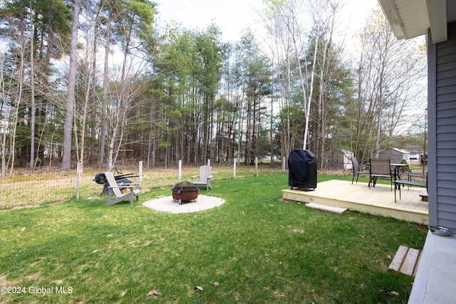 51 Rollman Cir, Hadley, NY 12835 - view of green lawn featuring an outdoor fire pit and a wooden deck