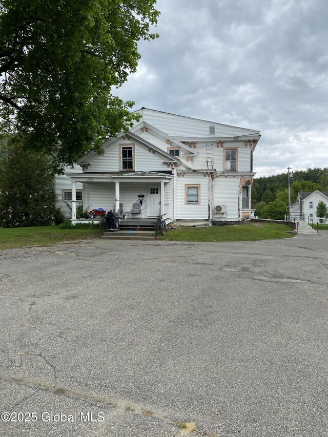 3847 Main St, Warrensburg, NY 12885 - view of front facade featuring a porch and driveway