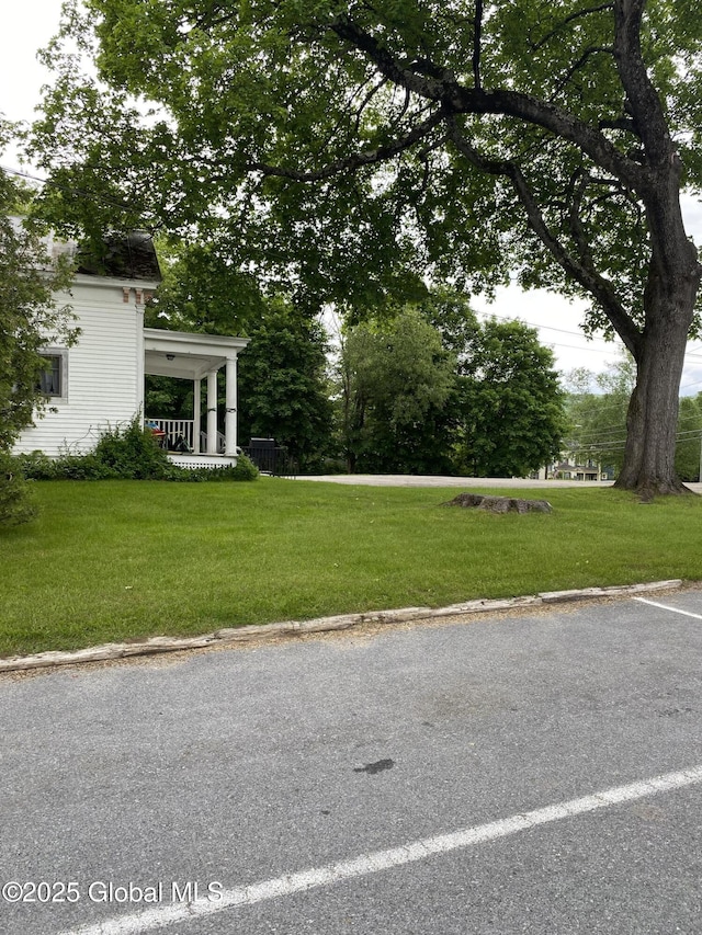 3847 Main St, Warrensburg, NY 12885 - view of grassy yard with covered porch