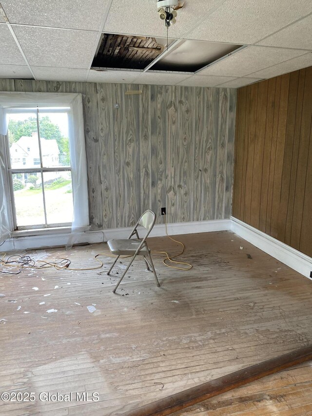 3847 Main St, Warrensburg, NY 12885 - unfurnished room featuring a paneled ceiling, hardwood / wood-style flooring, and baseboards