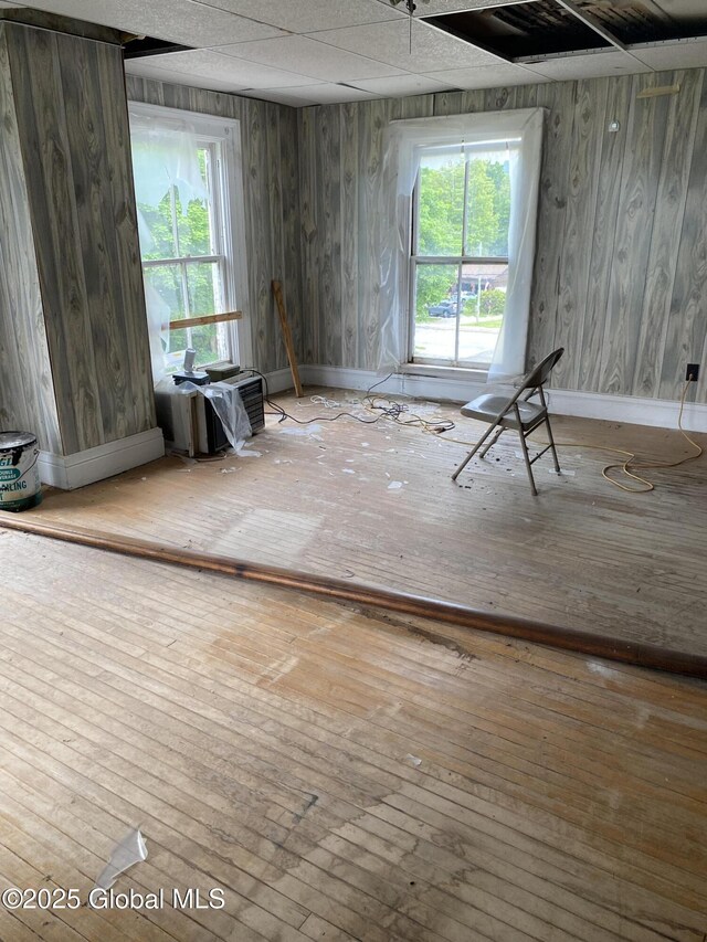3847 Main St, Warrensburg, NY 12885 - unfurnished room with hardwood / wood-style flooring, baseboards, and wood walls