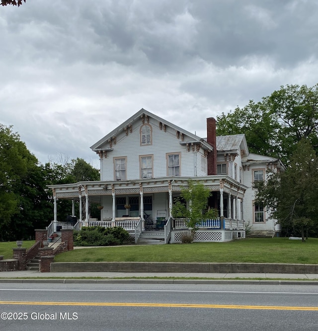 3847 Main St, Warrensburg, NY 12885 - italianate house with covered porch, a chimney, and a front yard