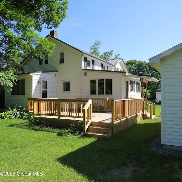 60 Bridge St, Broadalbin, NY 12025 - back of house with a chimney, a yard, and a wooden deck