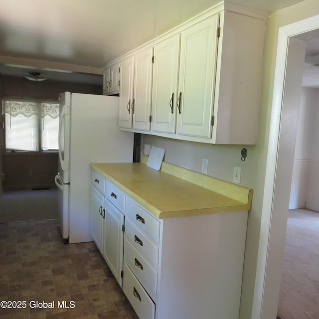60 Bridge St, Broadalbin, NY 12025 - kitchen with white cabinets, light countertops, and freestanding refrigerator