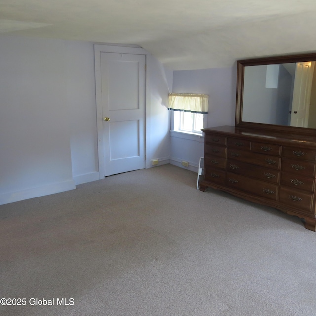60 Bridge St, Broadalbin, NY 12025 - unfurnished bedroom featuring light colored carpet and vaulted ceiling