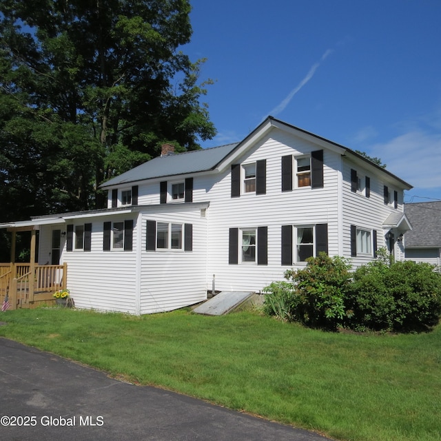 60 Bridge St, Broadalbin, NY 12025 - traditional-style home featuring a front yard and a chimney