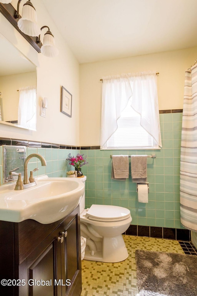 209 Whitehall Rd, Albany, NY 12209 - full bath with vanity, toilet, a wainscoted wall, and tile walls