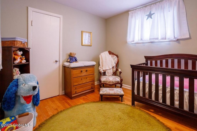 209 Whitehall Rd, Albany, NY 12209 - bedroom with a crib and wood finished floors