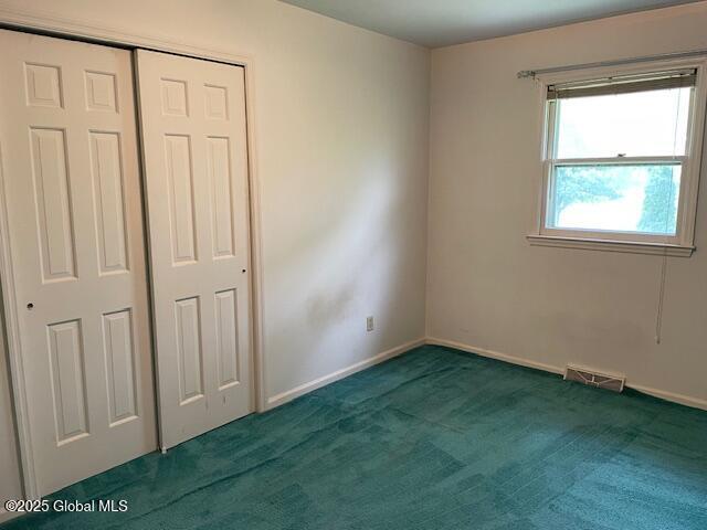 2070 Grand Blvd, Niskayuna, NY 12309 - unfurnished bedroom with carpet floors, a closet, and baseboards
