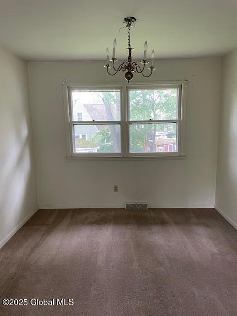 2070 Grand Blvd, Niskayuna, NY 12309 - carpeted empty room with healthy amount of natural light, a chandelier, and baseboards