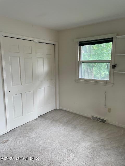 2070 Grand Blvd, Niskayuna, NY 12309 - unfurnished bedroom featuring a closet, carpet floors, and baseboards