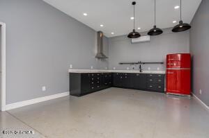 138 Lydon Ln, New Baltimore, NY 12087 - interior space featuring wall chimney exhaust hood, baseboards, recessed lighting, and light countertops