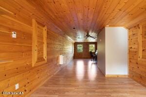 138 Lydon Ln, New Baltimore, NY 12087 - hall featuring wooden ceiling, wooden walls, wood finished floors, and radiator heating unit